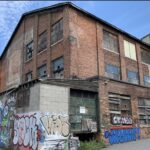 Old industrial brick building in Syracuse NY commercial corridor