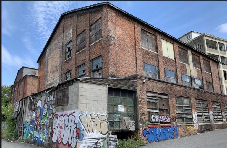 Old industrial brick building in Syracuse NY commercial corridor
